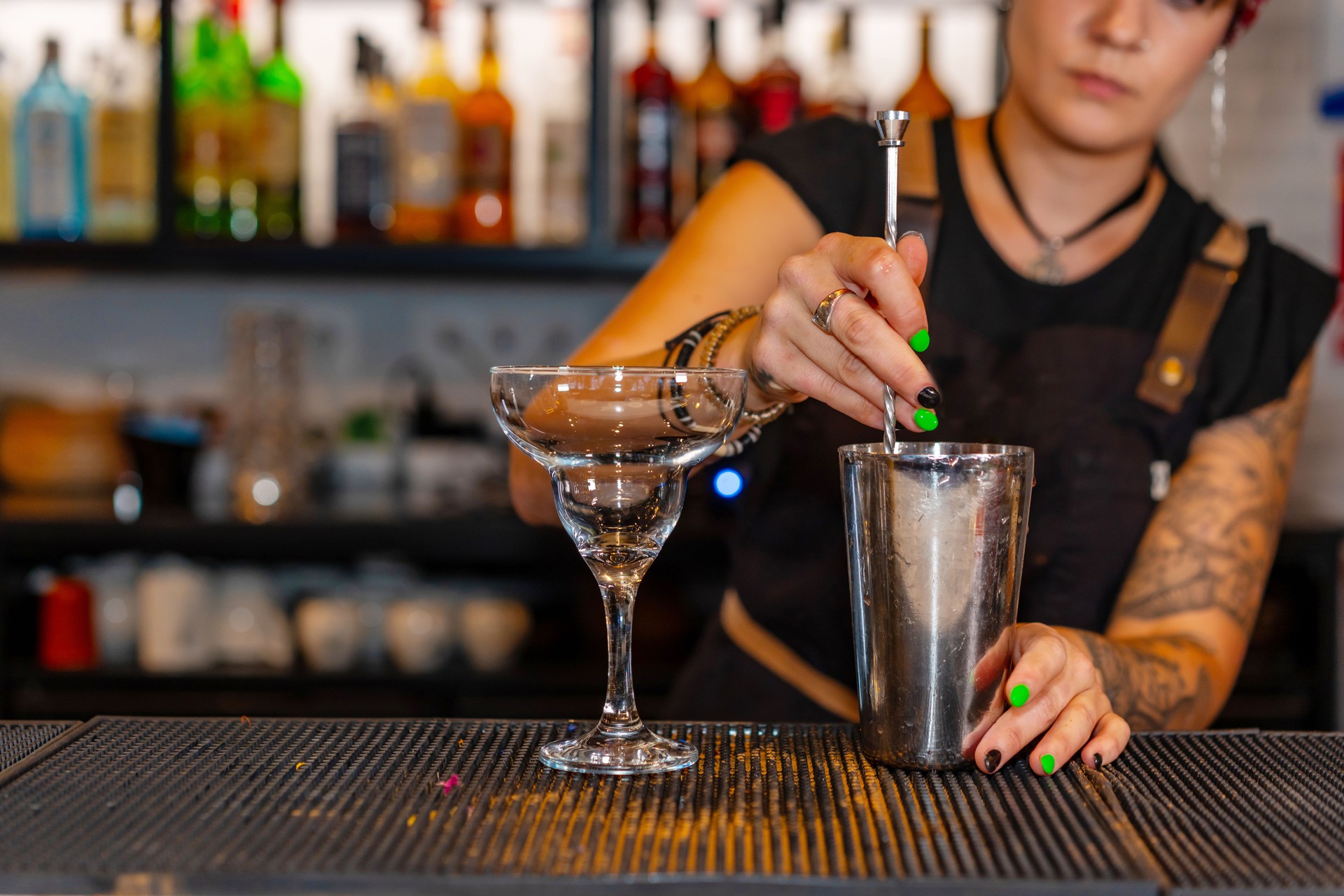 Professional bartender preparing a cocktail in the bar counter